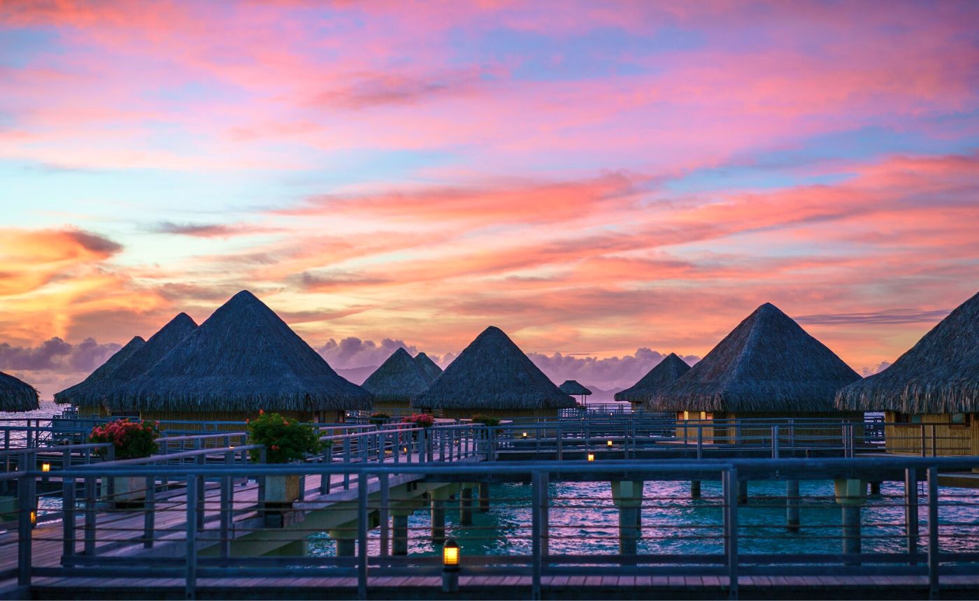bora bora hotels on water sunset background with small cabins nicest island to visit hotels over water cheapest island famous islands go to Bora Bora bora bora weather sunset lover places to stay in bora bora beach hotels facts 